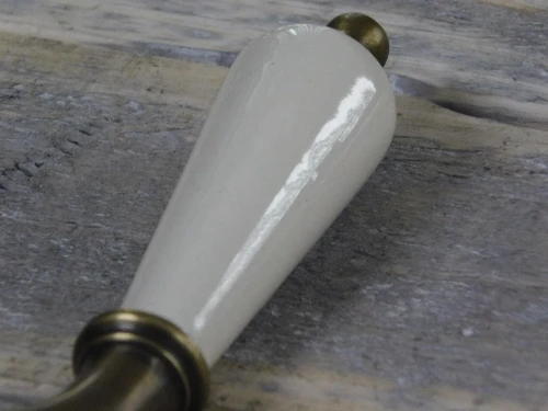 1 door handle brass with antique white ceramic handle, with mandrel.