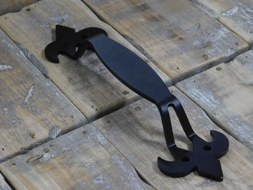 Large, high-quality wrought iron door handle with a medieval look