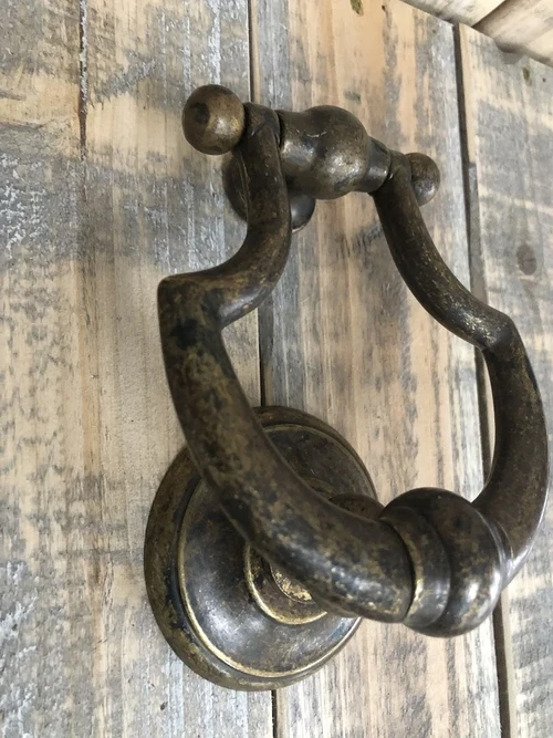 Door knocker, stylish and antique dark brass.