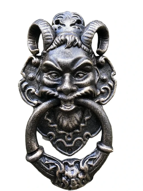 Cast iron bronze door knocker with devil's head.