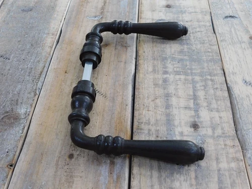 Door hardware set with 2 handles, 2 rosettes and a mandrel, dark brown