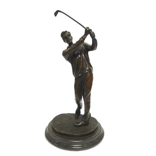 A bronze statue/sculpture of a golfer