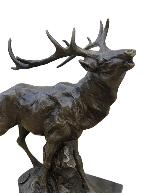 A bronze statue/sculpture of a deer