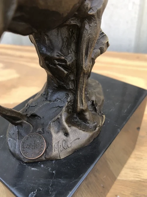 A bronze statue/sculpture of a deer