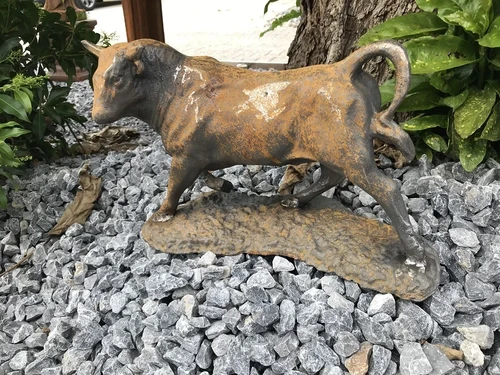 A beautiful statue of a bull, cast iron rest