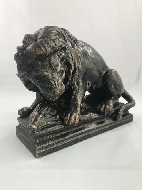 A beautiful statue of a lion with its prey, a boar, made of cast iron, bronze look!