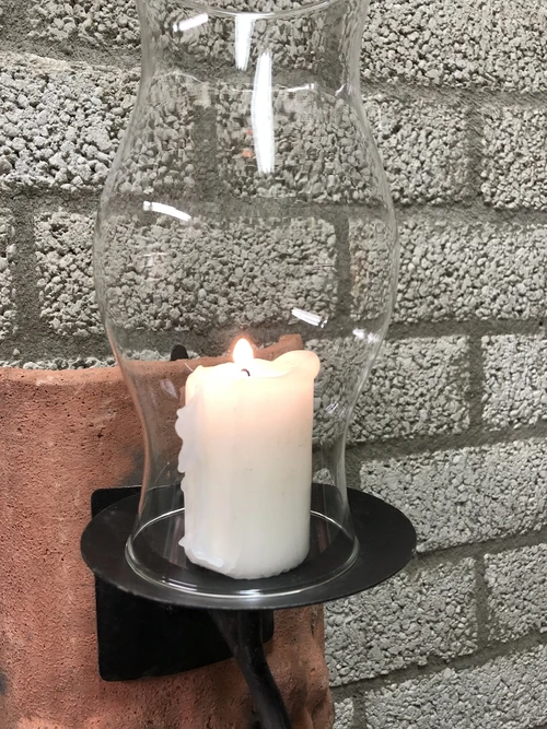 Wind light of roof tile with mythical image, with candlestick and glass flask.