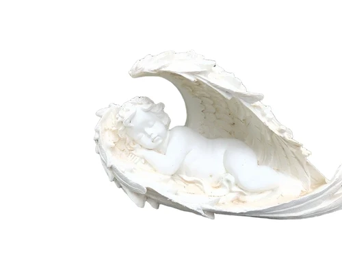 Statue of an angel sleeping in his wings, made of polystone