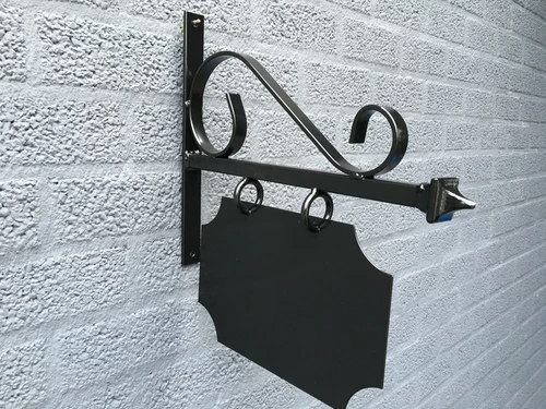 Nameplate facade sign for old downtown, advertising sign made of metal, painted black.