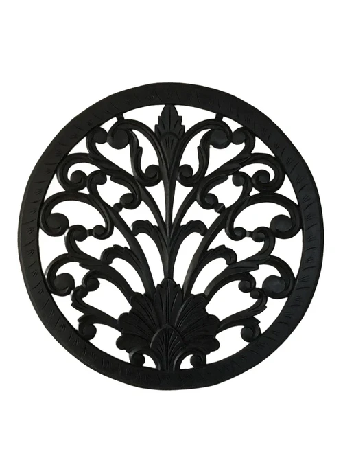 Wall ornament round, decoratively carved, black-brown.