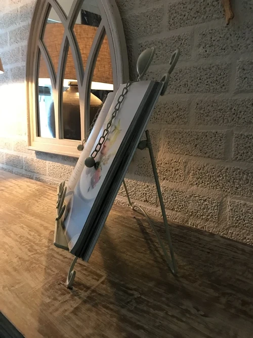 A white stand / holder for pieces of music, menus and, for example, books
