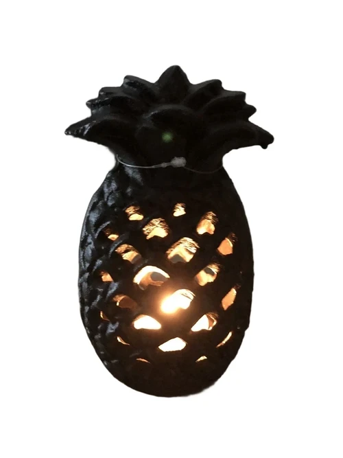 Cast iron lantern in the shape of a pineapple, atmospheric lighting.
