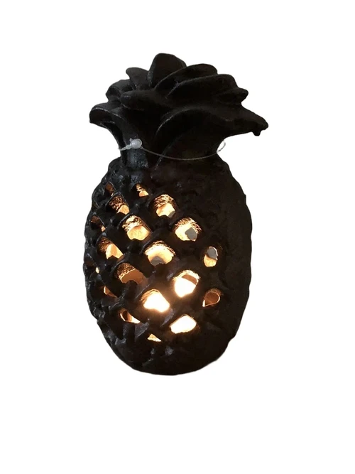 Cast iron lantern in the shape of a pineapple, atmospheric lighting.