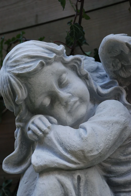 Beautiful sitting angel, full of detail, full of stone.