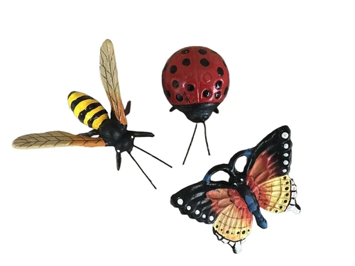 Cast iron figurines of a bee, butterfly and ladybird, full of colour.