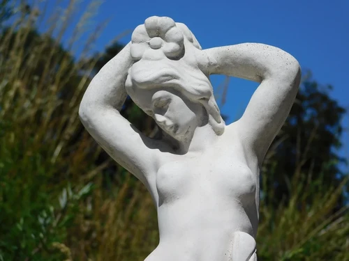 Beautiful, solid white stone sculpture of a standing lady – garden statue