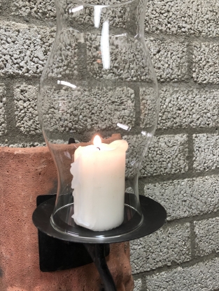 Wind light of roof tile with mythical image, with candlestick and glass flask.